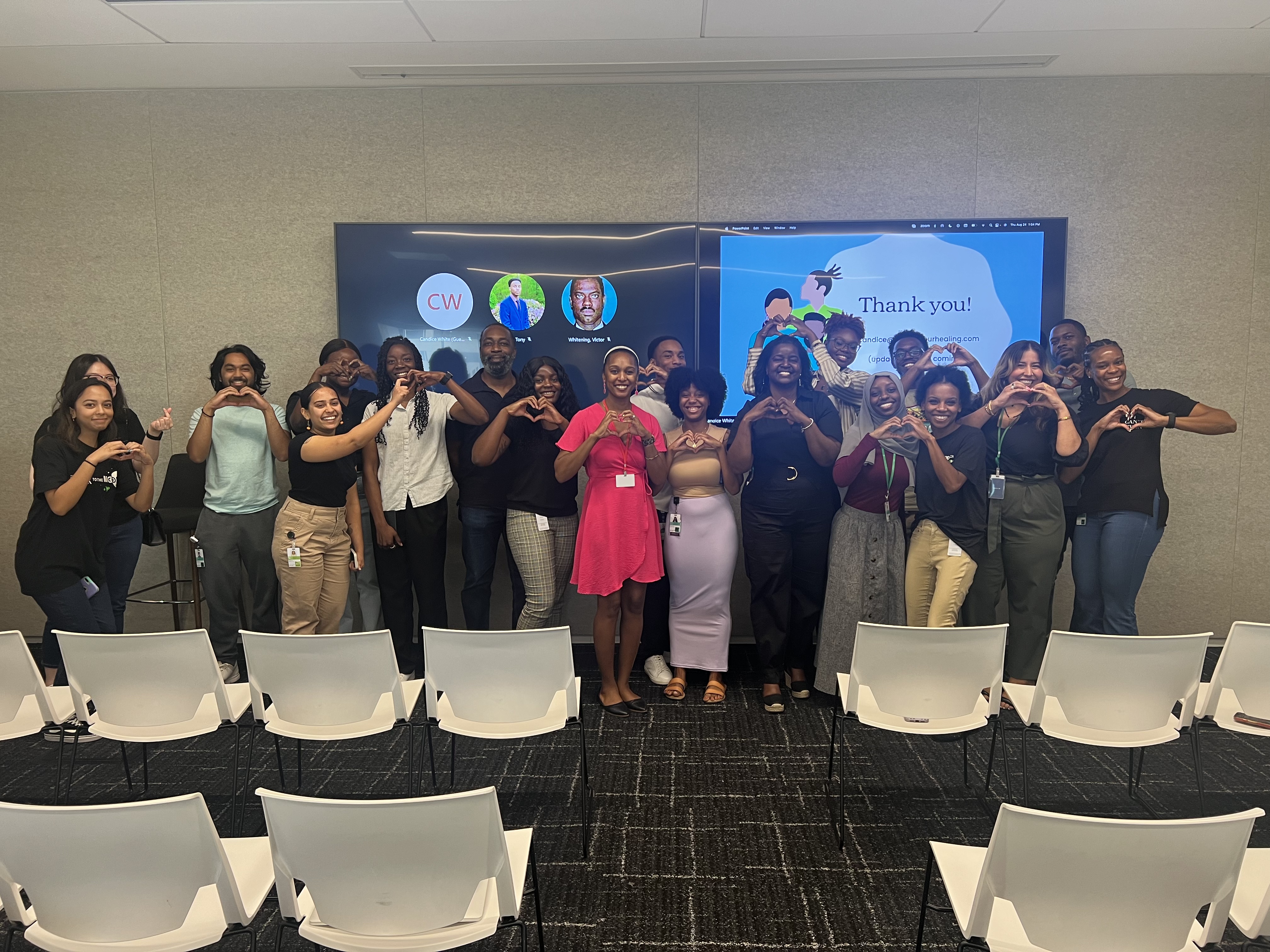 Candice White with a workshop group making heart hands after a session
